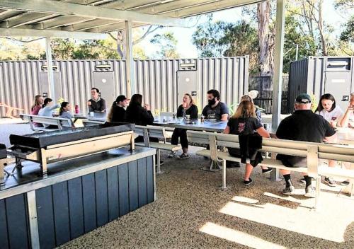 a group of people sitting at a table at St Helens Mountain Bike Base in St Helens