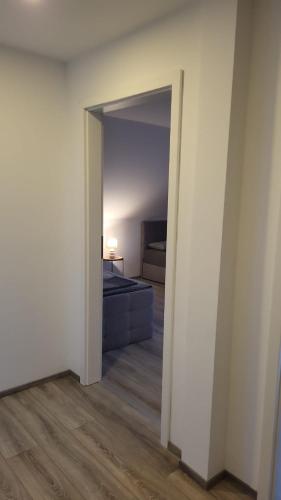 an open door to a bedroom with a bed in a room at Apartment Home in NRW in Gladbeck