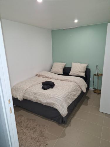 une chambre avec un lit avec un chapeau dessus dans l'établissement l'échappée verte, à Le Mée-sur-Seine