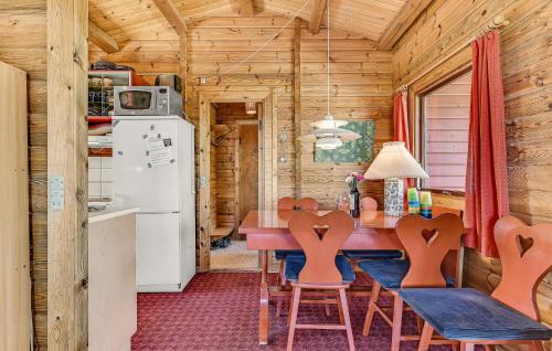 a kitchen and dining room with a table and chairs at 2 Bedroom Lovely Home In Faaborg in Bøjden