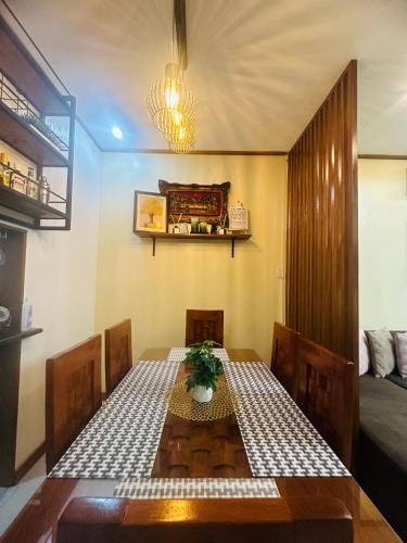 a dining room with a table and a bed at Rivero Transient House in San Fernando