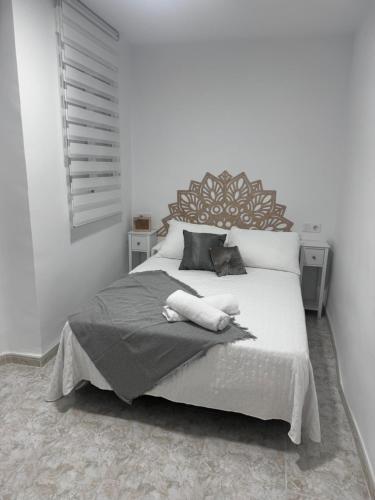 a bedroom with a bed with a large headboard at Olas del Mar in Puerto de Mazarrón