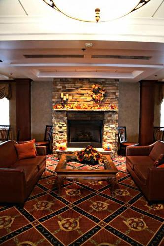 a living room with couches and a fireplace at Holiday Inn Express Hotel & Suites Hagerstown by IHG in Hagerstown
