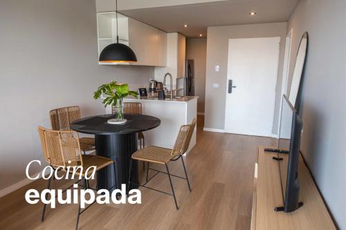 a kitchen and dining room with a table and chairs at Milenia Soho by iPPA in Buenos Aires