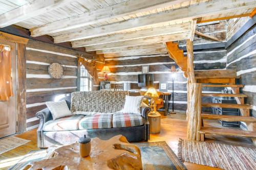 a living room with a couch and a wooden wall at half-Mi to Lake Cabin on 43 Acres in Shell Knob! in Shell Knob