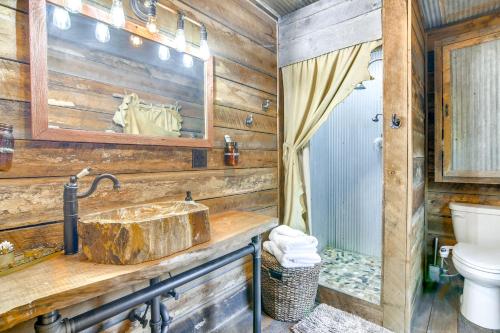 a bathroom with a sink and a toilet at half-Mi to Lake Cabin on 43 Acres in Shell Knob! in Shell Knob