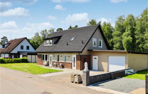 a home with a garage and a house at Gorgeous Home In Lammhult in Lammhult