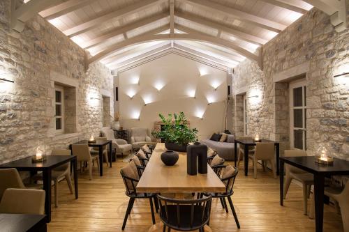 a restaurant with tables and chairs in a room at BASSA MAINA Villas & Suites in Areopolis
