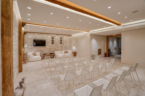 a large room with chairs and a living room at BASSA MAINA Villas & Suites in Areopolis
