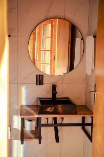 a bathroom with a sink and a mirror at Blue Sunset 3 in Urubici