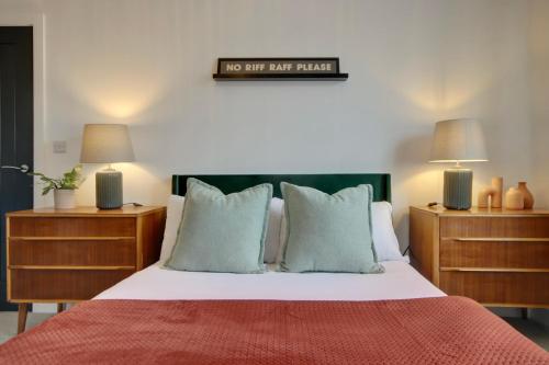 a bedroom with a bed with two nightstands and two lamps at Clover lodge Portsmouth luxury home with off road free parking in Portsmouth