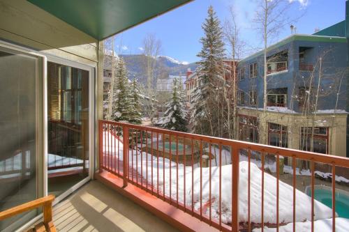 a balcony with a view of a snow covered yard at River Run Village by Keystone Resort in Keystone