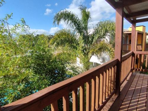 a balcony of a house with palm trees at Apartamentos La Playa in Piriápolis