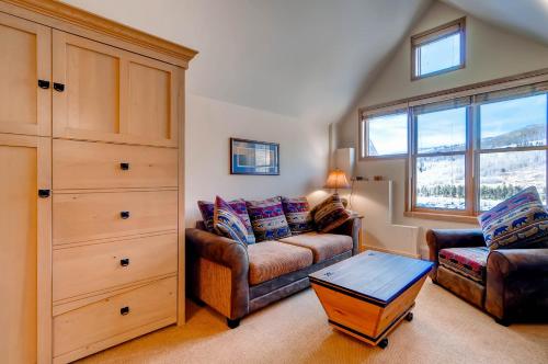 a living room with a couch and a table at River Run Village by Keystone Resort in Keystone
