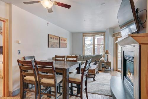 a dining room with a table and chairs and a fireplace at River Run Village by Keystone Resort in Keystone