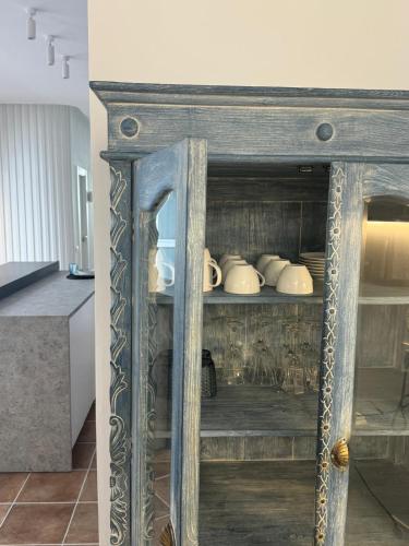 a wooden cabinet with dishes in it in a kitchen at Guest House Espinardo Murcia Casa Universitaria in Murcia
