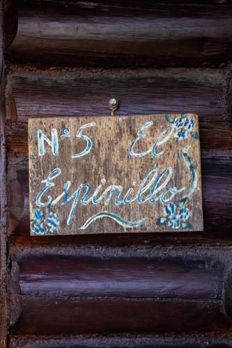 a sign on a wooden wall with a no entry sign at Posada de Nono in Nono