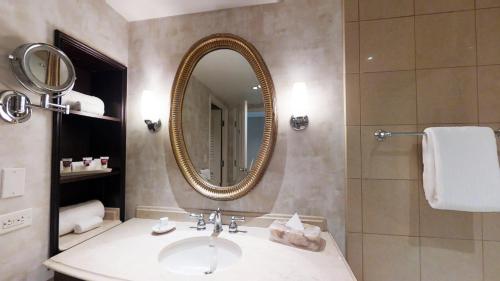 a bathroom with a sink and a mirror at Harrah's New Orleans Hotel & Casino - A Caesars Rewards Destination in New Orleans