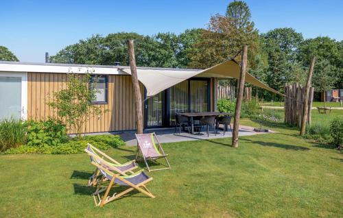 a couple of chairs and a tent in a yard at Awesome Home In Voorthuizen With Wifi in Voorthuizen