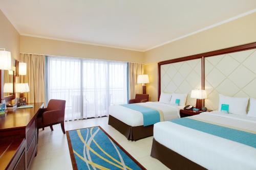 Voodi või voodid majutusasutuse Pacific Islands Club Guam toas