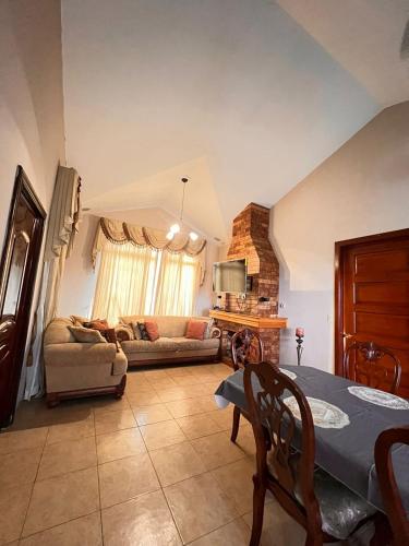 a living room with a table and a couch at Casa Bonita Boquete in Alto Boquete