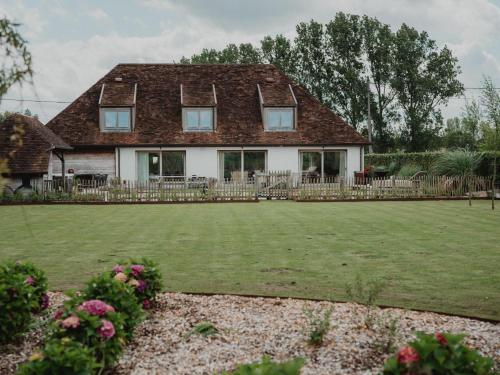 a house with a lawn in front of it at Villa Noortem in Maldegem