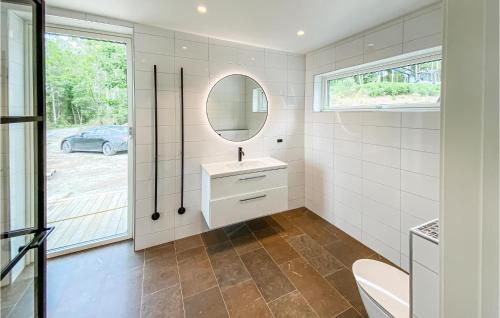 a bathroom with a sink and a mirror at Lovely Home In Bolmsö With Sauna in Bolmsö