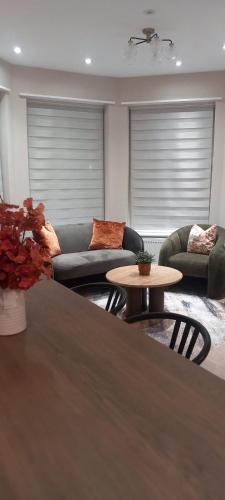 a living room with a couch and a table at The golden place in London