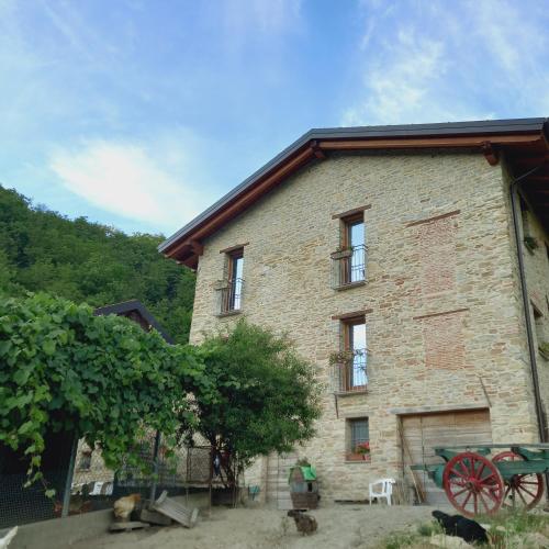 a large brick building with a table in front of it at Il Tesoro di MiRo in Cartosio