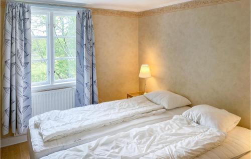 two beds in a bedroom with a window at 5 Bedroom Gorgeous Home In Edsbruk in Edsbruk