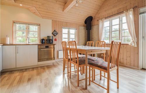 a kitchen with a table and chairs in a room at Holiday Home Bork Hytteby Hemmet Denmark in Falen