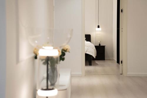 a room with a vase on a table with a bedroom at Shanghai Yi Du B&B - Family Suite 500m to Nanjing West Rd Near People's Square -Credit Cards Accepted in Shanghai