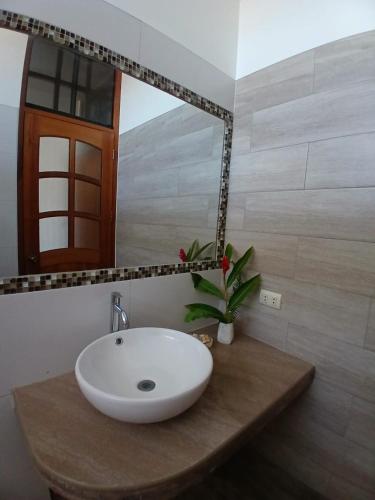 a bathroom with a white sink and a mirror at Alojamiento Familiar Custodia in Tarapoto