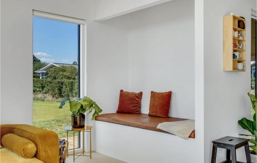 a window seat in a bedroom with a view of the yard at Beach Front Home In Haderslev in Haderslev