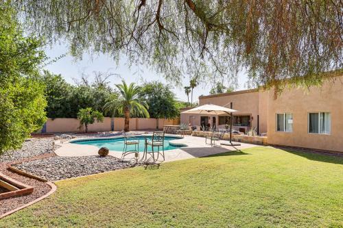 a backyard with a pool with chairs and a table at Pool Access! Scottsdale Biohack Healthy Dream Home in Phoenix