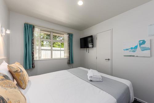 a bedroom with a large white bed and a window at 315 Motel Riccarton in Christchurch