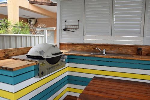 a grill on a outdoor kitchen with colorful stripes at Mariner 16 Flat 2 - Bring your own linen. in South West Rocks