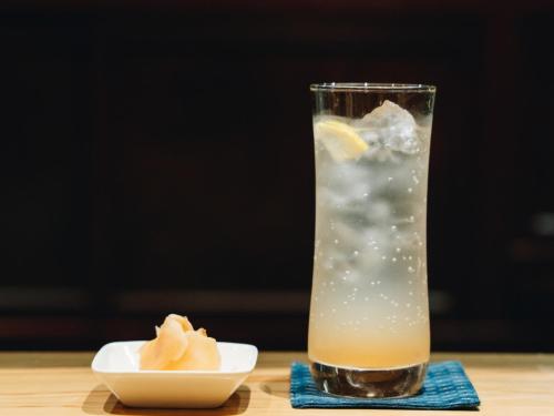 a drink with a lemon and a bowl on a table at RITA Yame Fukushima in Yame