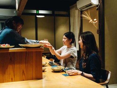 two people sitting at a table eating food at RITA Yame Fukushima in Yame