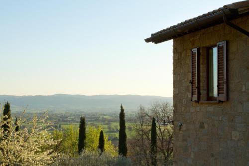 a stone building with a view of a mountain at Villa Degli Ulivi in Assisi