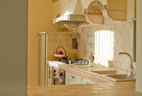a kitchen with a sink and a stove at Villa Degli Ulivi in Assisi