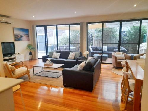 a living room with a couch and a table at Perfect on Orton in Ocean Grove