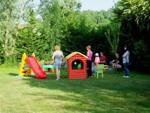 a group of people standing around a play house at Agriturismo Adriano Pedretti in Badia Polesine