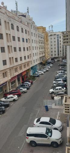 a row of parked cars in a parking lot at Muscat Galaxy Hostel in Muscat