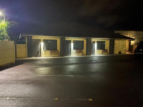 a building with a parking lot at night at Kauri Court Motel and Apartments in Palmerston North