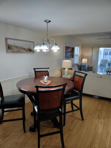 a dining room with a table and chairs and a couch at Center of Saint Augustine Beach in St. Augustine