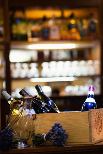 a box of wine bottles on a table with flowers at Hotel Abácie & Wellness in Valašské Meziříčí