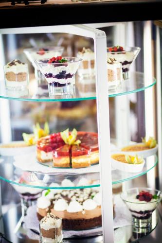 a display case filled with different types of desserts at Hotel Abácie & Wellness in Valašské Meziříčí