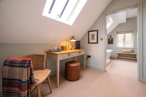a attic room with a desk and a toilet at The Bottle & Glass Inn - Book All 3 Rooms in Henley on Thames