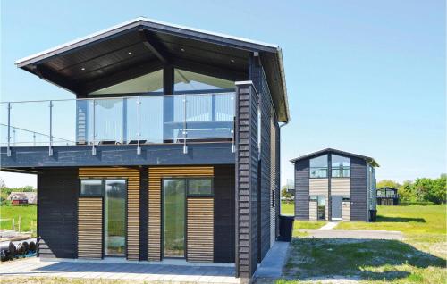 a glass house with a balcony on top of it at Holiday Home Frederikshavn 41 in Frederikshavn